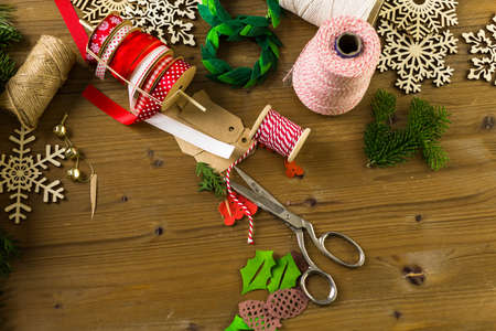 Wrapping Christmas gifts in recycled brown paper with vintage style at home.の写真素材