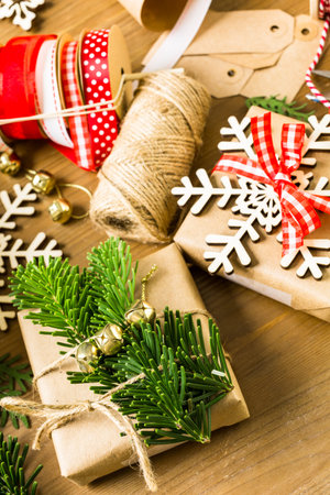 Wrapping Christmas gifts in recycled brown paper with vintage style at home.の写真素材