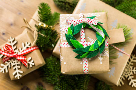 Wrapping Christmas gifts in recycled brown paper with vintage style at home.の写真素材
