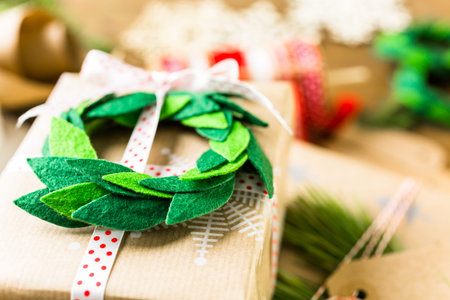 Wrapping Christmas gifts in recycled brown paper with vintage style at home.の写真素材