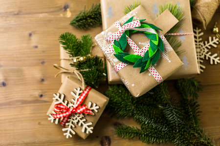 Wrapping Christmas gifts in recycled brown paper with vintage style at home.の写真素材