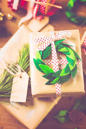 Wrapping Christmas gifts in recycled brown paper with vintage style at home.の写真素材