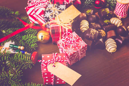 Wrapping assorted chocolates in small boxes for Christmas presents.の写真素材