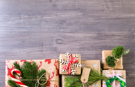 Christmas gifts wrapped in brown paper with red ribbons.の写真素材