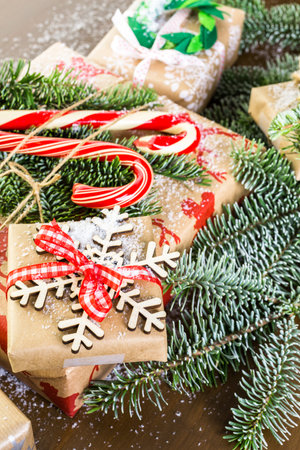 Christmas gifts wrapped in brown paper with red ribbons.