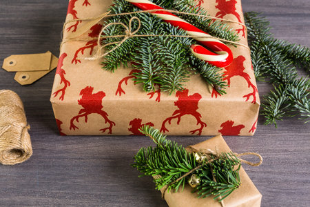 Christmas gifts wrapped in brown paper with red ribbons.