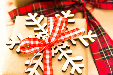 Christmas gifts wrapped in brown paper with red ribbons.の写真素材