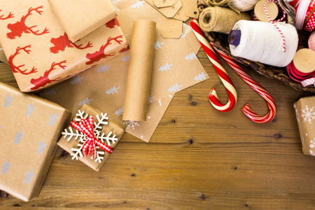 Christmas gifts wrapped in brown paper with red ribbons.