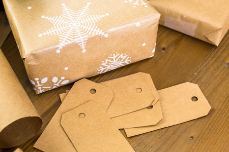 Christmas gifts wrapped in brown paper with red ribbons.