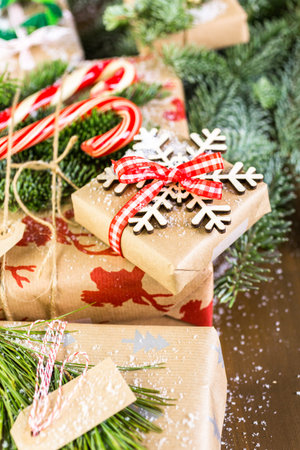 Christmas gifts wrapped in brown paper with red ribbons.