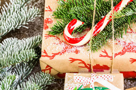 Christmas gifts wrapped in brown paper with red ribbons.の写真素材