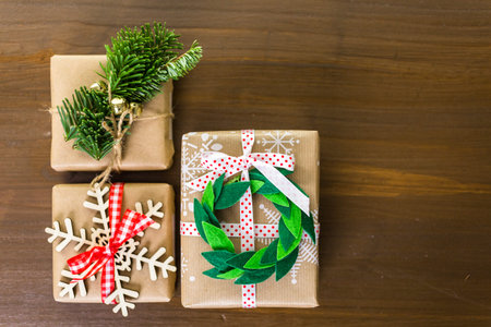 Christmas gifts wrapped in brown paper with red ribbons.