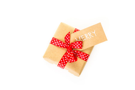 Christmas gifts wrapped in brown paper with red ribbons.