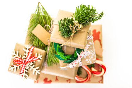 Christmas gifts wrapped in brown paper with red ribbons.