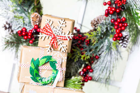 Christmas gifts wrapped in brown paper with red ribbons.の写真素材