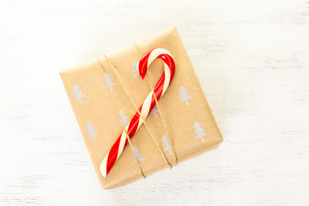 Christmas gifts wrapped in brown paper with red ribbons.