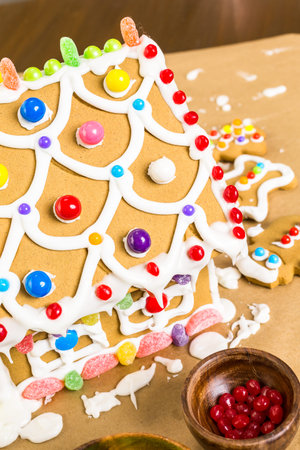 Building gingerbread house for Christmas.の写真素材