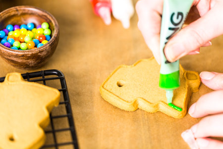 Decorating gingerbread cookies with royal icing and colorful candies.