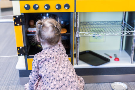 Cute toddler girl playing with toys.