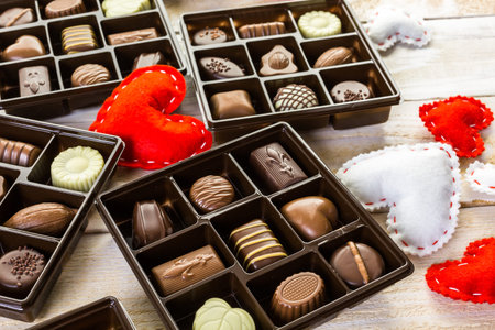 Assorted chocolates on wood table.
