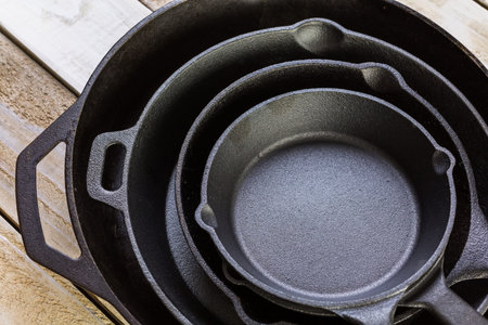 Cast iron skillet on rustic wood table.