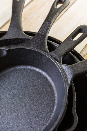 Cast iron skillet on rustic wood table.