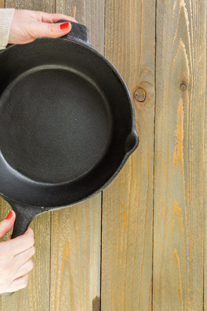 Cast iron skillet on rustic wood table.
