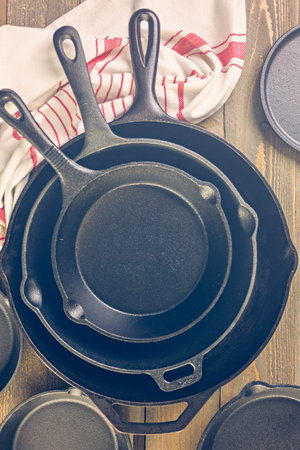 Cast iron skillet on rustic wood table.の写真素材