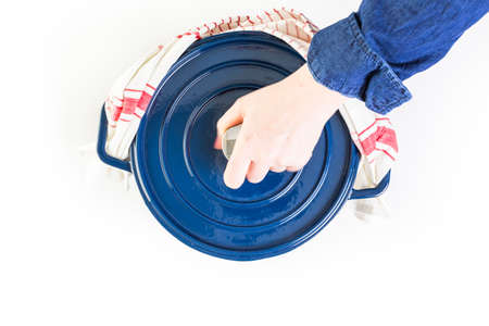 Enameled blue cast iron covered dutch oven on a white background.の写真素材