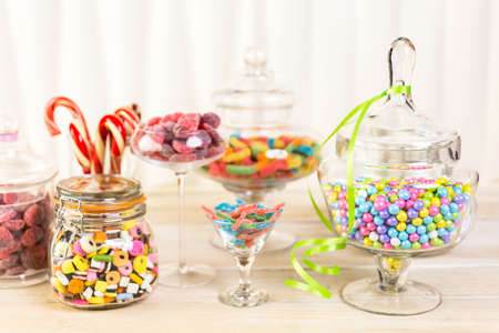 Multicolored candies in glass candy jars.の写真素材