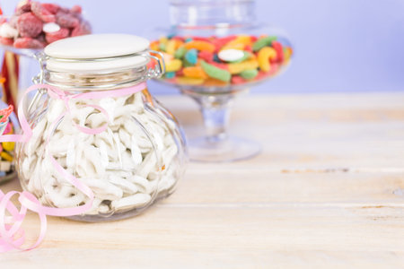 Multicolored candies in glass candy jars.
