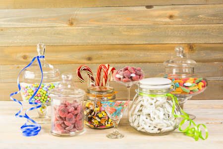 Multicolored candies in glass candy jars.の写真素材