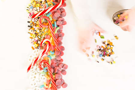 Multicolored candies on a white table.の写真素材