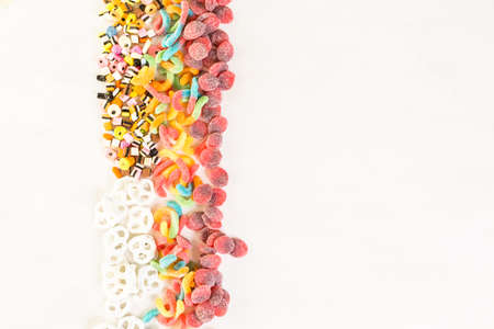 Multicolored candies on a white table.の写真素材