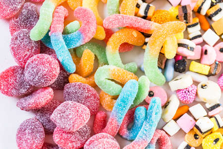 Multicolored candies on a white table.の写真素材