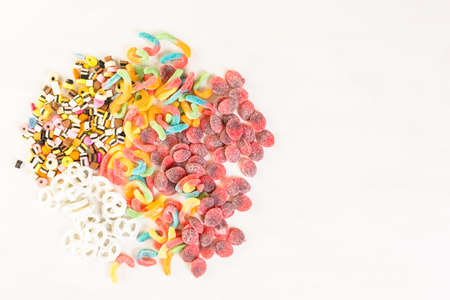 Multicolored candies on a white table.の写真素材