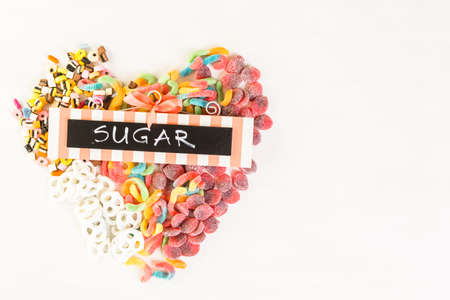 Multicolored candies on a white table.の写真素材