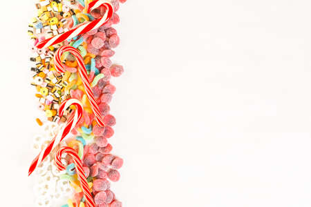 Multicolored candies on a white table.の写真素材