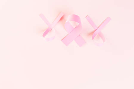 Womens health symbol in pink ribbon on wooden board.の写真素材