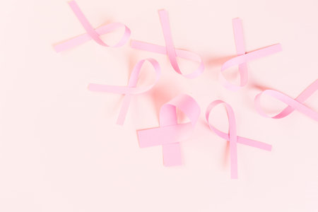 Womens health symbol in pink ribbon on wooden board.