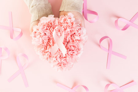 Womens health symbol in pink ribbon on wooden board.