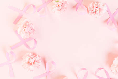 Womens health symbol in pink ribbon on wooden board.の写真素材