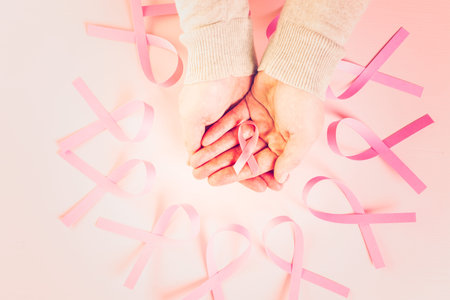 Womens health symbol in pink ribbon on wooden board.