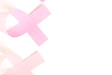 Womens health symbol in pink ribbon on a white bacckground.の写真素材