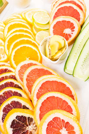 Ingredients for preparing detox citrus infused water as a refreshing summer drink.の写真素材