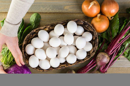 Ingredients for dyeing Easter eggs on a wood table.の写真素材