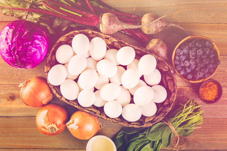 Ingredients for dyeing Easter eggs on a wood table.の写真素材