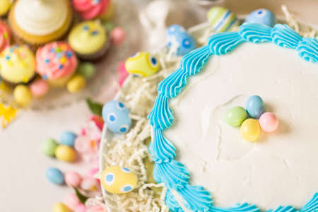 Dessert table set with cake and cupcakes for Easter brunch.の写真素材