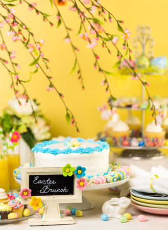 Dessert table set with cake and cupcakes for Easter brunch.の写真素材