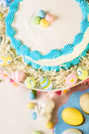 Dessert table set with cake and cupcakes for Easter brunch.